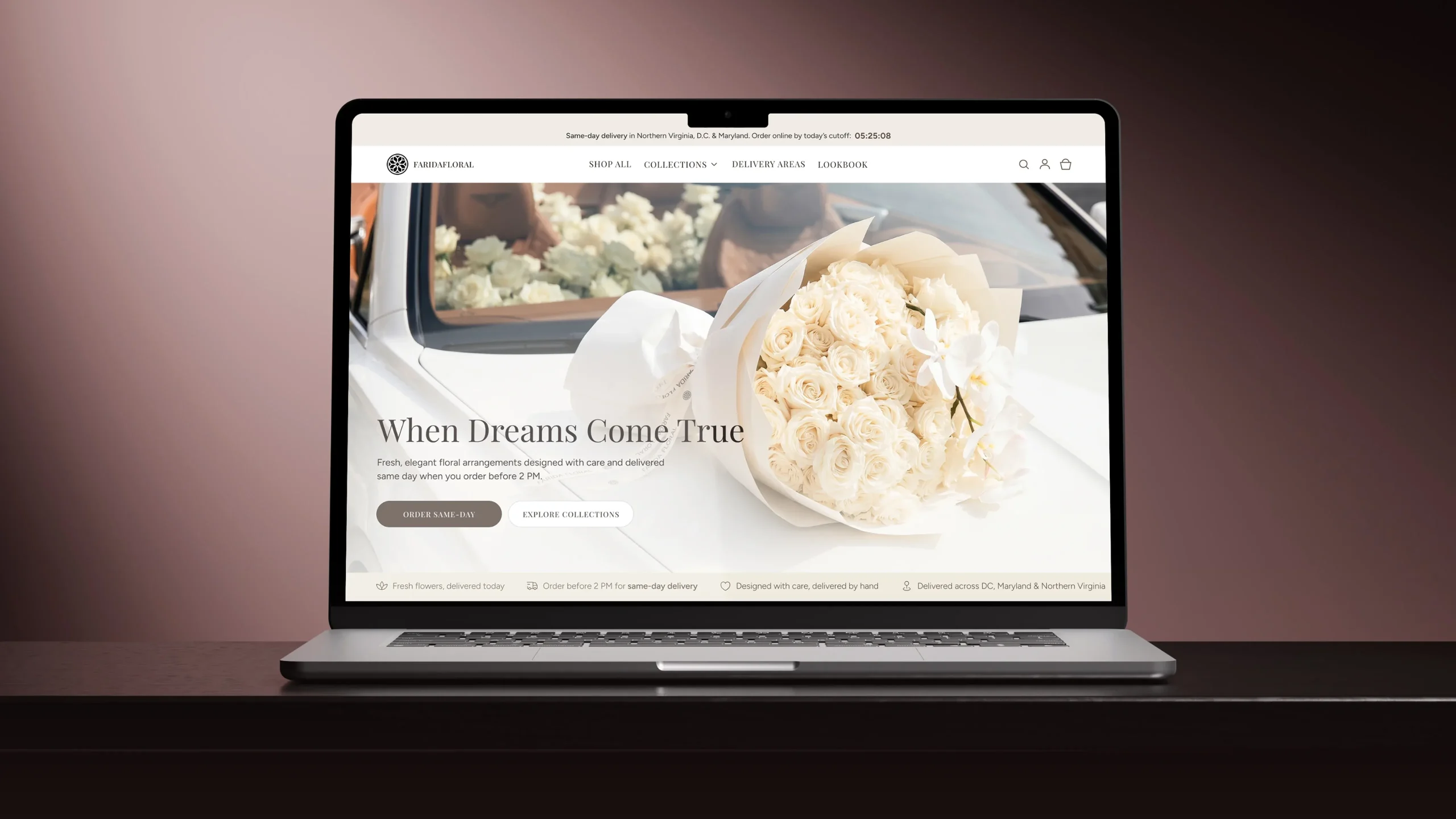 Laptop showing an online florist homepage with a bouquet of ivory roses and orchids