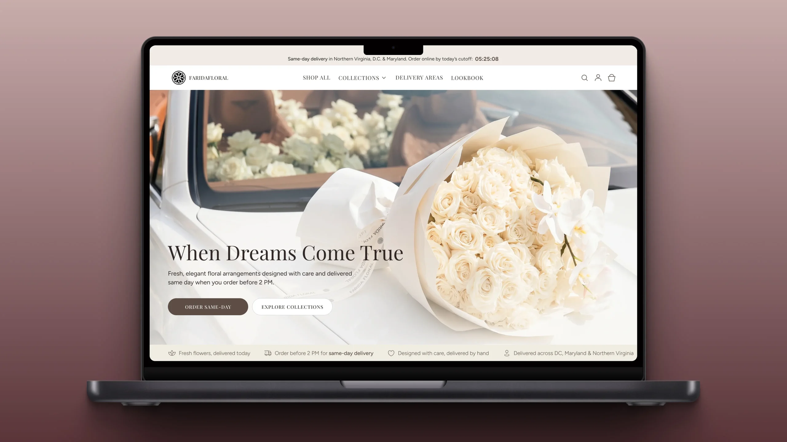 Laptop displaying a floral shop homepage with a large bouquet of white roses