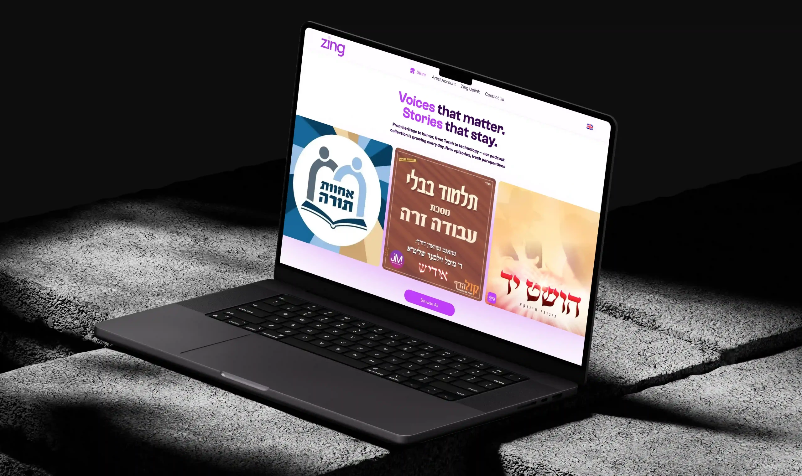 Angled laptop displaying a Jewish music website with featured album and podcast covers